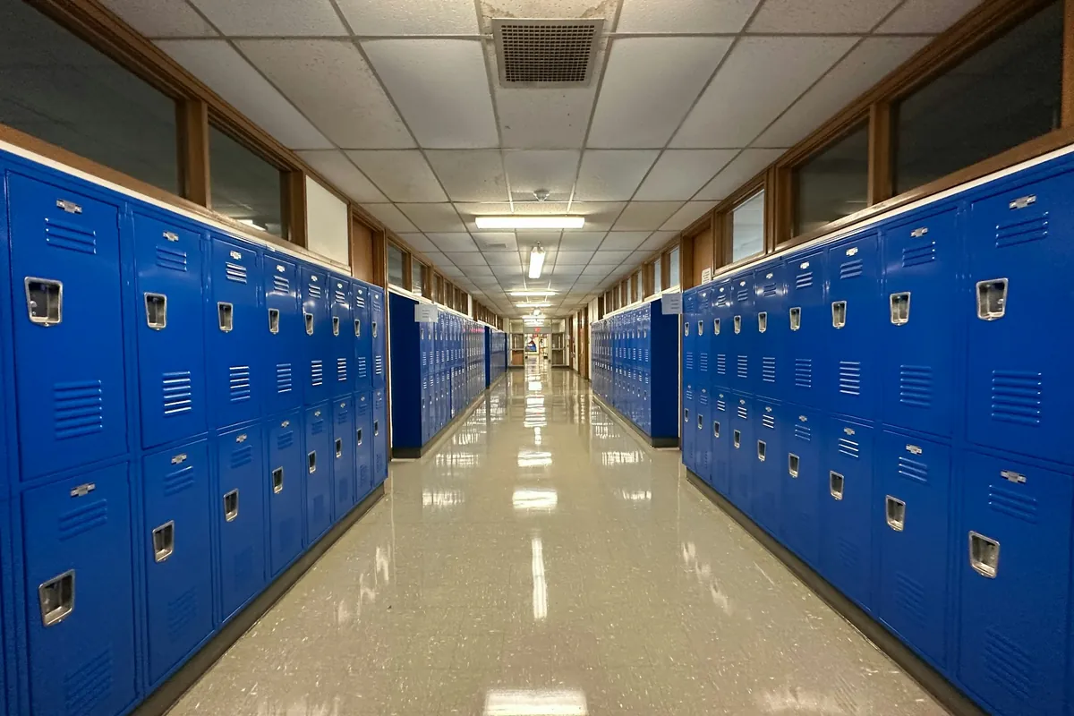 Long row of blue steel lockers installed along a hallway